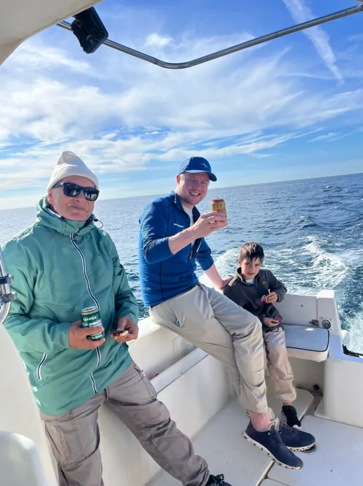 Friends enjoying a drink on board during a fishing trip in Málaga