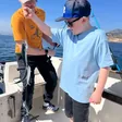 Boy landing his first catches with his father on a fishing trip in Málaga