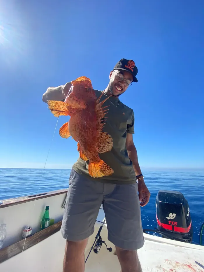 Angler showing a scorpionfish caught on board the Fishing Trips Málaga boat