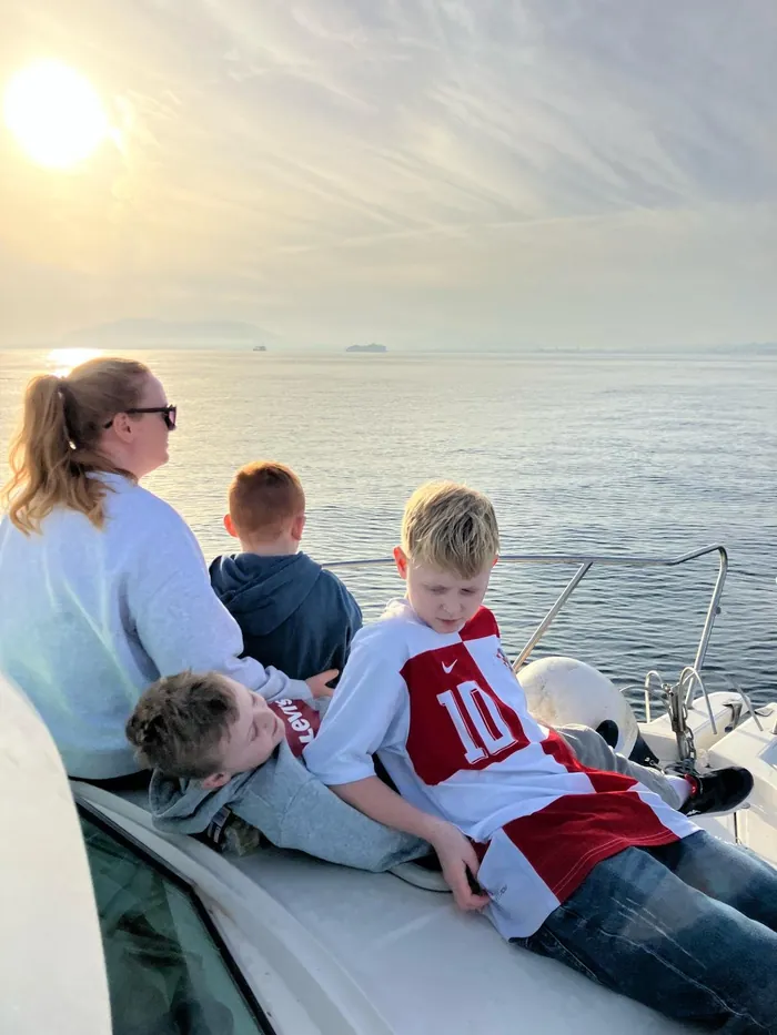 Family enjoying the sunset on board the fishing boat in Málaga